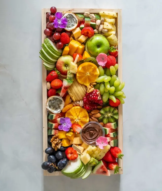 Savor the juicy allure of our medium fruit platter, serving 8-10 guests with an explosion of flavor and beauty. Measuring 18.5 inches by 9 inches, this delectable selection features a variety of irresistibly fresh fruits, complemented by a decadent chocolate dip, and your choice of chicken or beef mortadella cheese, nuts, and delightful fruit skewers. Elevate your table's aesthetics and delight your guests with this perfect choice for any occasion