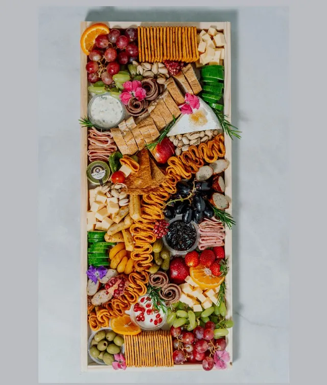 Elevate your gatherings with our large charcuterie board, serving 15-20 guests. Measuring 25.5 inches by 11 inches, it features a visually stunning selection of cold cuts, including chicken or beef mortadella, honey-glazed chicken ham, chicken pepperoni, and chicken or beef salami, along with an exquisite assortment of cheeses, dips, fresh fruits, crisp veggies, and flavorful accompaniments. Thoughtfully curated and tailored to your serving needs, this sophisticated centerpiece is perfect for elevating any gathering with its rich flavors and enticing presentation.