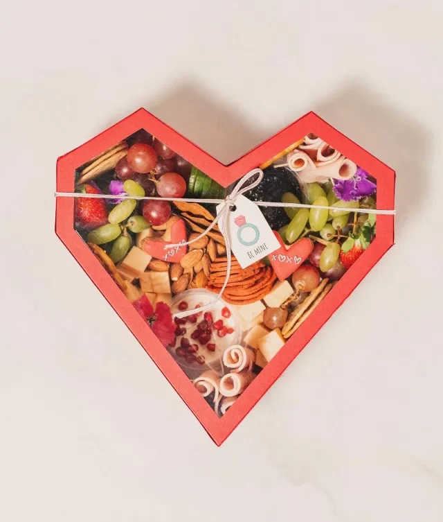 Heart-shaped platter box: Medium-sized, featuring an assortment of Chicken or beef mortadella, cold cuts, fruits, crackers, and accoutrements. Complete with delectable dips including Date and Lime Chutney, and Garlic and Herb Cheese. Ideal for serving 4 or more guests.