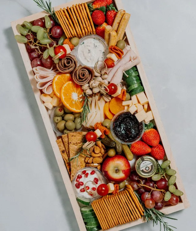 Experience culinary excellence with our medium charcuterie board, serving 8–10 guests. Measuring 18.5 x 9 inches, it features a visually stunning selection of cold cuts, including chicken or beef mortadella, honey-glazed chicken ham, chicken pepperoni, and chicken or beef salami, along with an exquisite assortment of cheeses, dips, fresh fruits, crisp veggies, and flavorful accompaniments. Thoughtfully curated and tailored to your serving needs, this sophisticated centerpiece is perfect for elevating any gathering with its rich flavors and enticing presentation.