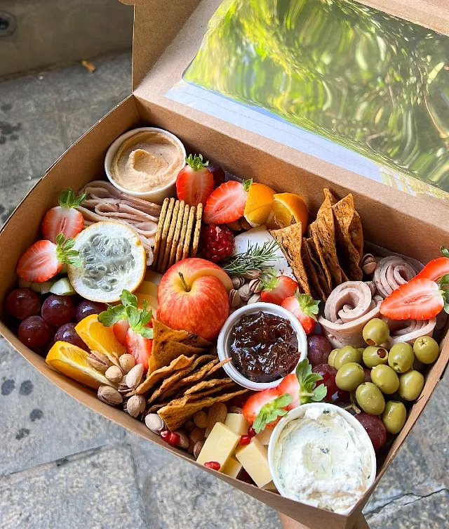 Indulge in a thoughtfully curated selection of premium cheeses, gourmet cold cuts, and delightful accompaniments, ideal for up to four people. The cheese selection features a rich assortment of five exquisite varieties: Smoked Scamorza, Cheddar, Herb & Garlic Neufchâtel, Chili Pepper Neufchâtel, and Pistachio & Cranberry Cheese Ball.