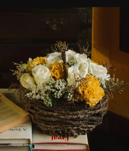 Gift a loved one this adorable small floral arrangement with white roses in a handmade kithul basket.