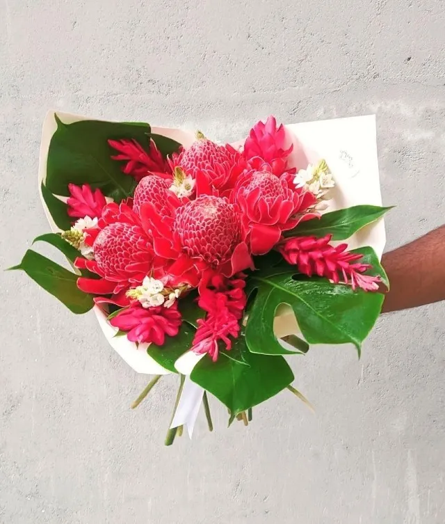 Gift a stunning red tropical flower arrangement to your loved ones.