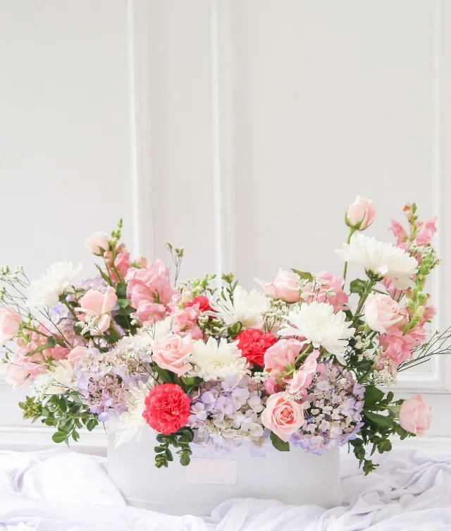 Gift your loved one a large arrangement with roses, hydrangeas, chrysanthemums, and snapdragons in a white box