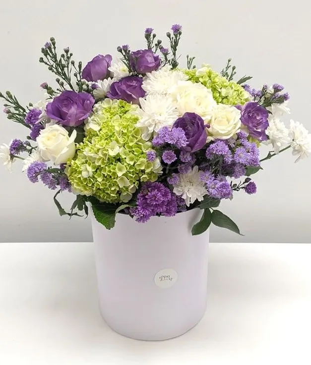 Surprise your loved one with an enchanting flower arrangement featuring lilies, roses, chrysanthemums, and hydrangeas, elegantly presented in a beautiful white box.
