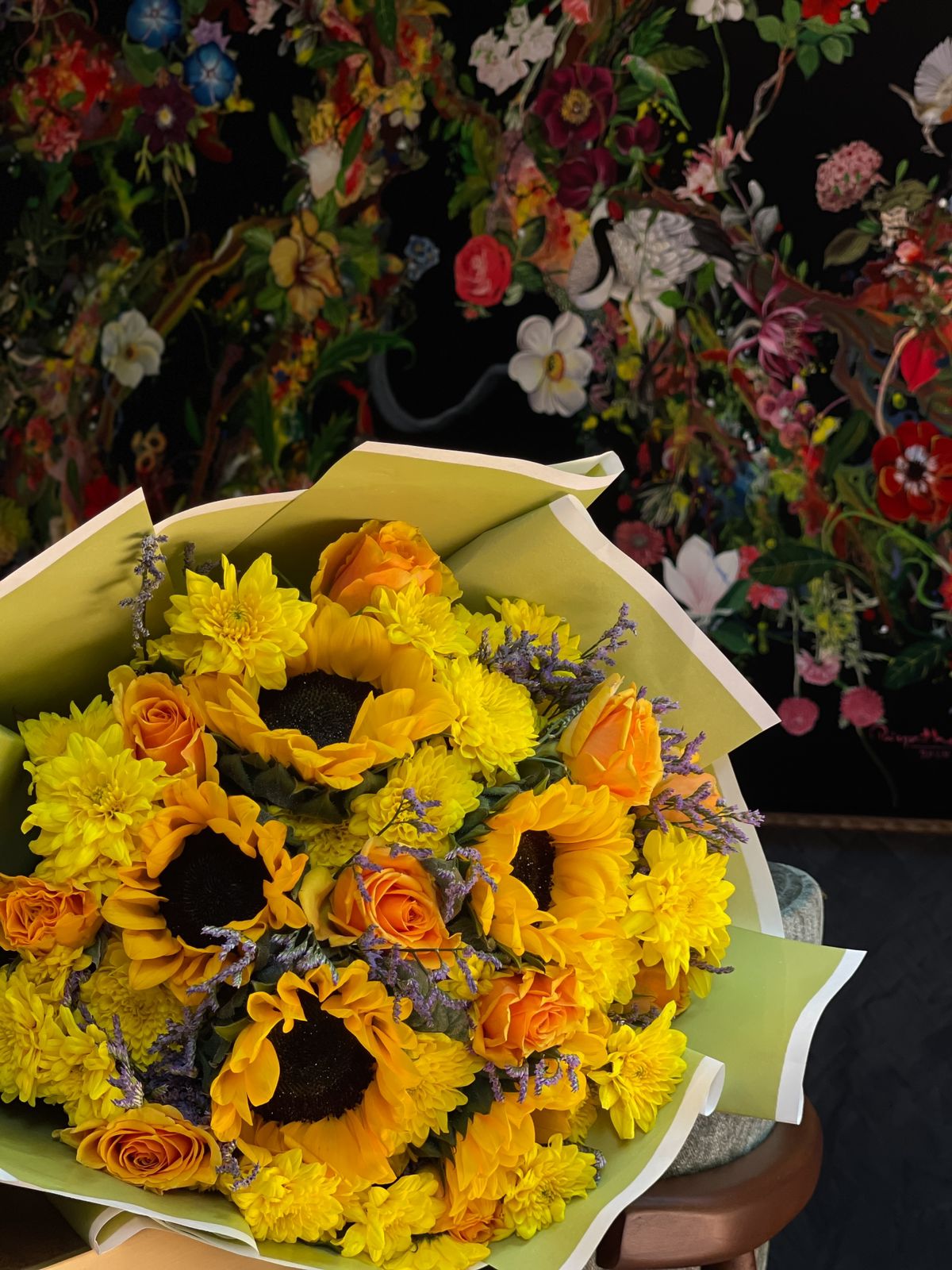 Gift your loved one a gorgeous handheld bouquet of sunflowers, accompanied by gorgeous accent florals