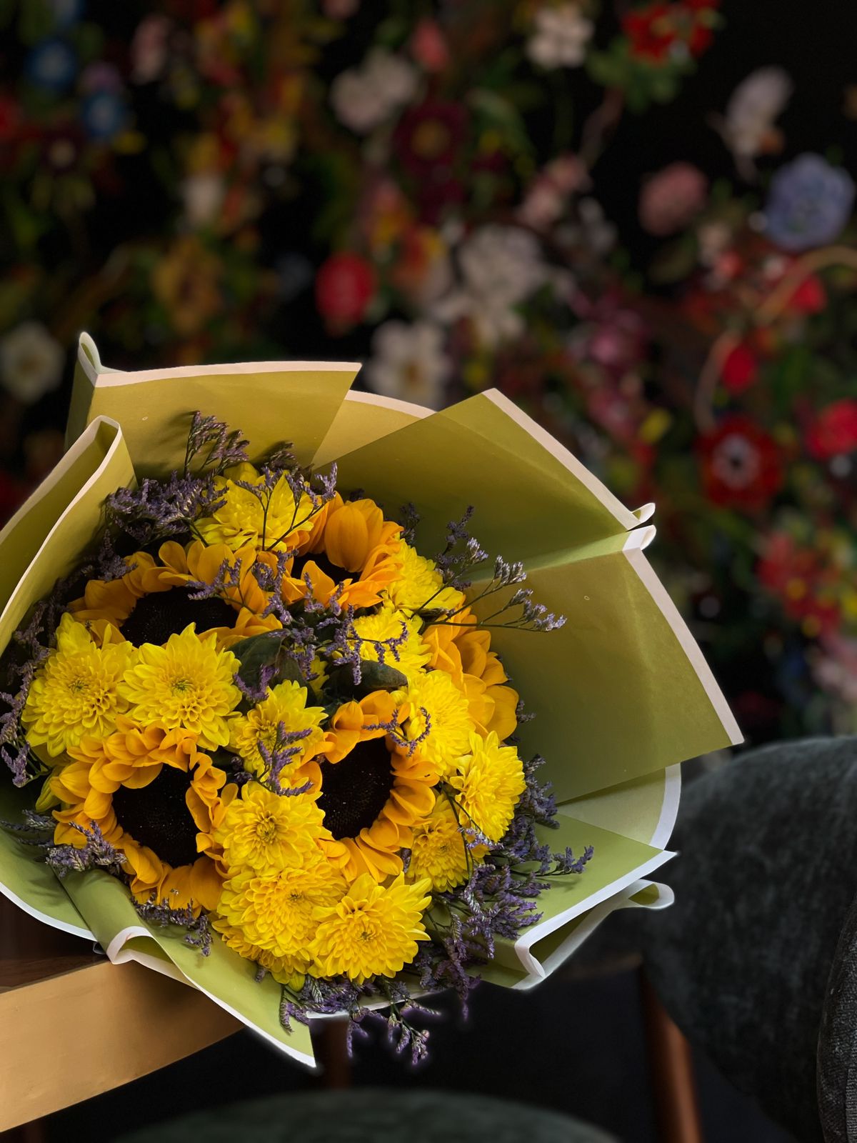 Gift your loved one a gorgeous handheld bouquet of sunflowers, accompanied by gorgeous accent florals