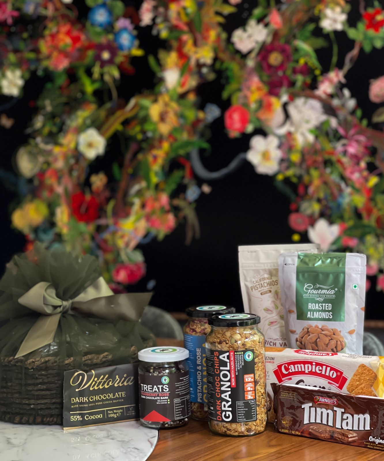 Delight your loved ones with a thoughtfully curated hamper filled with delicious and healthy treats. Item Includes: Dark choc chips Granola Pistachios & Rose Granola Vittoria dark chocolate Treats Cranberry Rose Tim Tam original Campiello Gran Chicco Roasted Almonds sour cream Rich valley pistachios