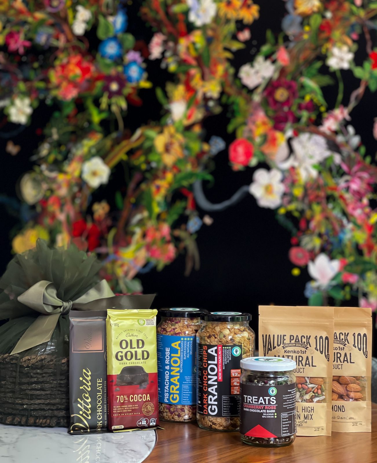 Delight your loved ones with a thoughtfully curated hamper filled with delicious and healthy treats. Item Includes: Natural high protein mix Almond Dark choc chips Granola Pistachios & Rose Granola Vittoria dark chocolate Treats Cranberry Rose Cadbury Old Gold 70% Cocoa