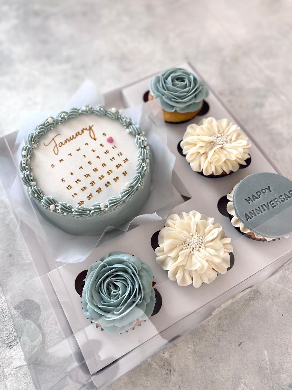 Surprise your loved one with a delightful assortment featuring a calendar-designed bento cake, accompanied by a box of five regular-sized cupcakes.