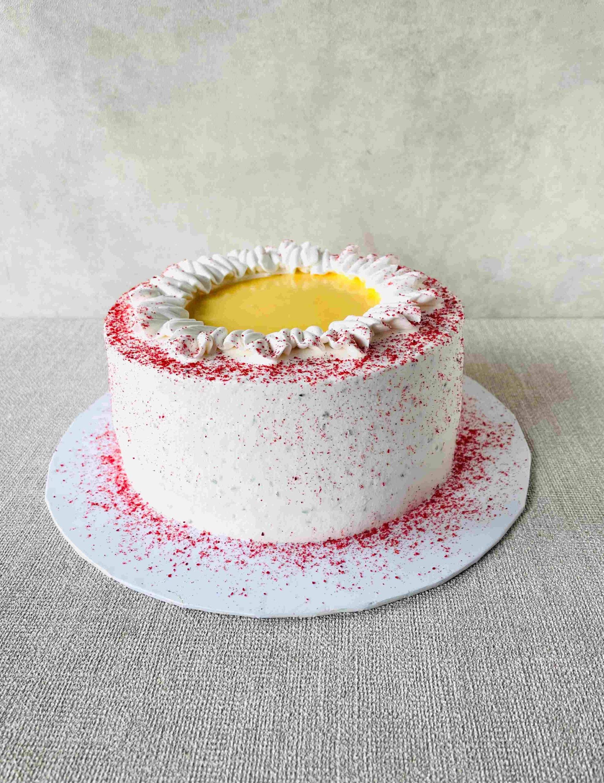 Lemon Basil Berry Delight – Fragrant basil seed sponge cake filled with zesty lemon curd and basil-strawberry compote, wrapped in light whipped cream. A fresh and vibrant treat! Measuring 7 inches in diameter and 3-4 inches in height.
