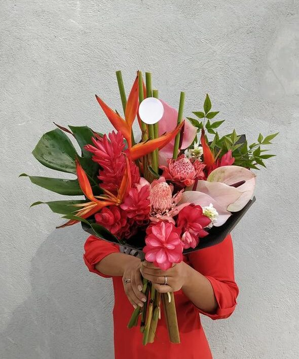 A vibrant red tropical flower bouquet. A stunning expression of warmth, joy, and tropical elegance