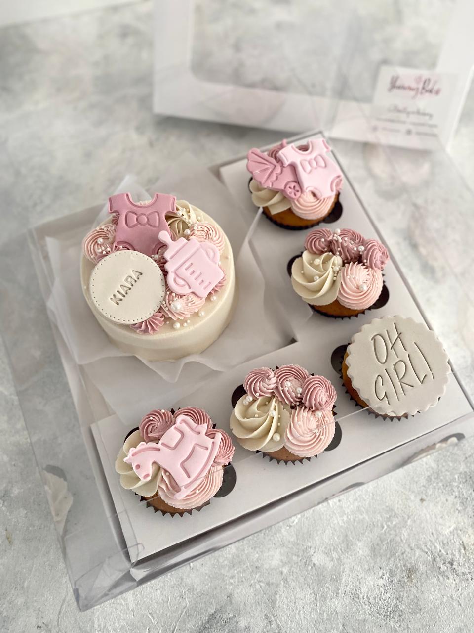 Surprise your loved one with a delightful Baby Arrival Celebration Assortment, featuring a bento cake alongside a box of five regular-sized cupcakes. It’s the perfect way to commemorate the joyous occasion of welcoming a new baby into the world.